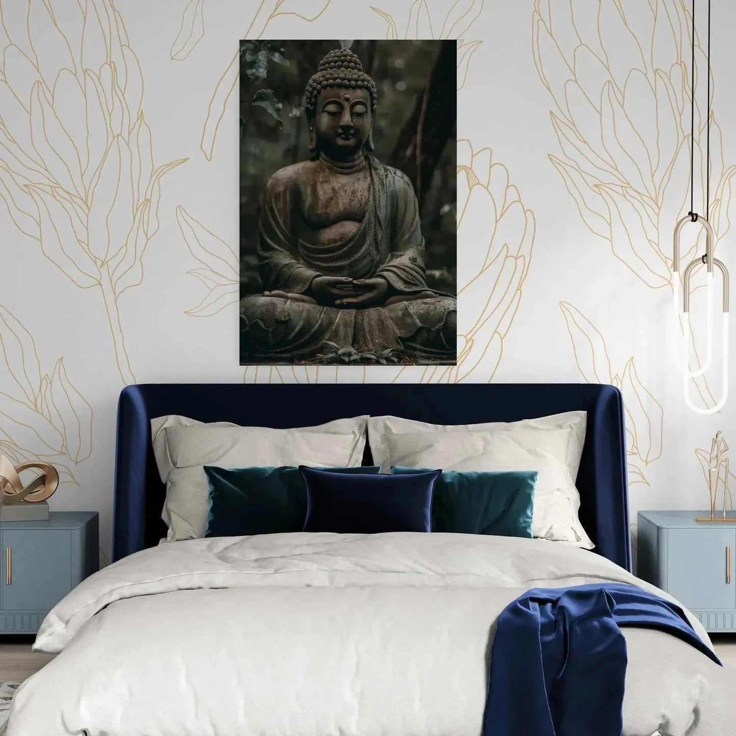 A bedroom with a navy velvet headboard, light bedding, and blue accent pillows features a framed "Buddha in Meditation: ZenArtBliss.com's Fusion of Art and Spirituality" from Printify hanging above the bed. The wallpaper showcases floral patterns, complemented by pendant lights on either side of the bed.