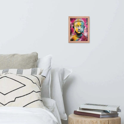 A vibrant framed poster of a stylized Modern Buddha Painting hangs on a white wall above a neatly arranged bed with plush pillows and a decorative cushion. A bedside table to the right holds a stack of books beside a white bed covered in crisp linen. A wooden tray with a black bowl and a jar rests on the bed, adding a homely touch to the modern, serene bedroom setting.